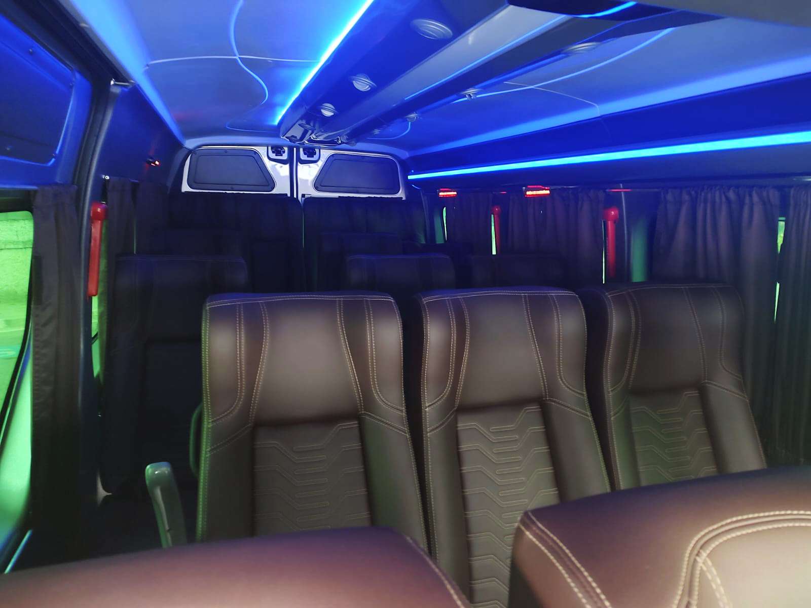 Interior de van com poltronas de couro e luz azul